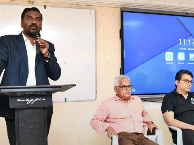 A speaker addressing the room at Thapar Institute, with Poorit trainers seated alongside faculty